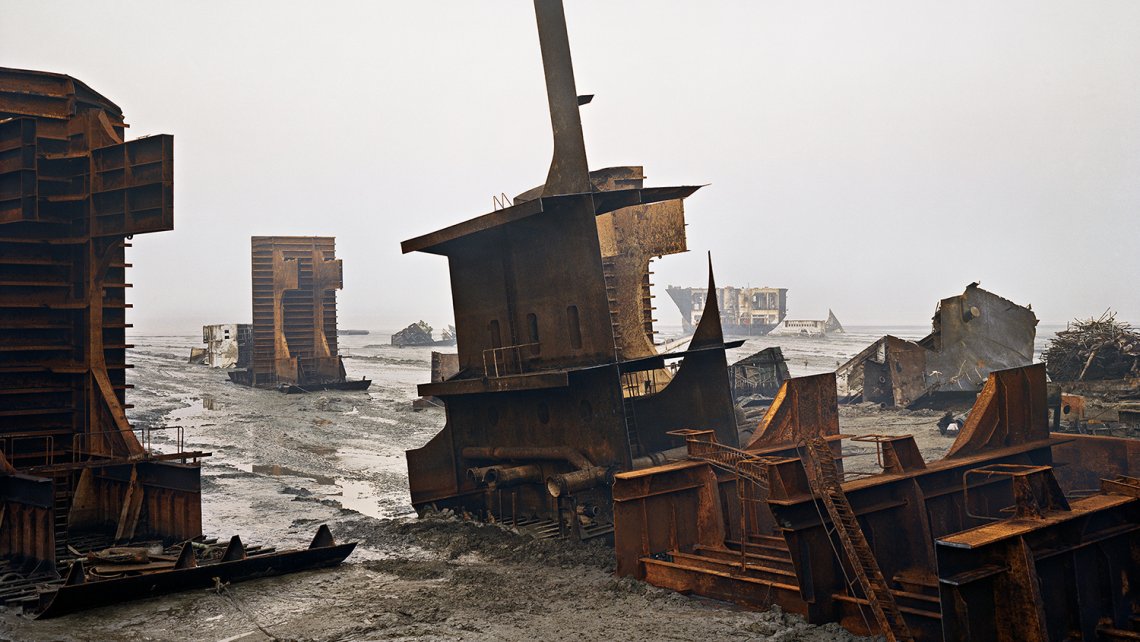 Large metal shipwreck on a shallow water beach