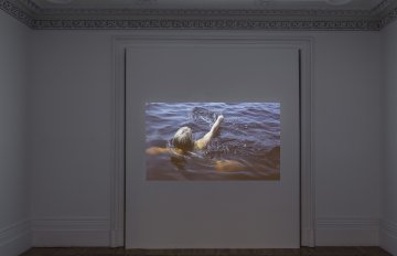 video footage projected onto a white wall
