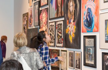 girl admiring artwork in the exhibition