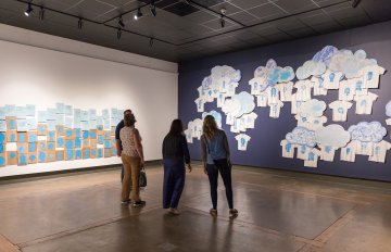 people admiring the artwork of the exhibition