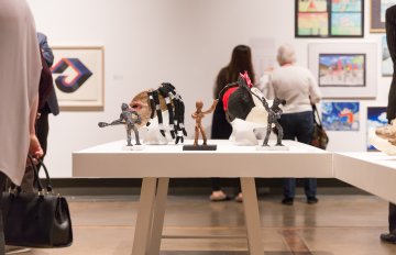 people admiring the artwork of the exhibition