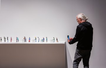 miniature statues on display in gallery