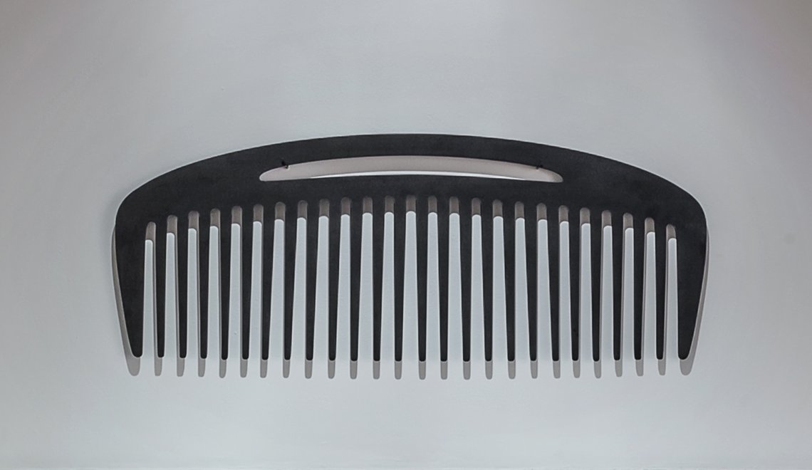 Large comb hung on a wall