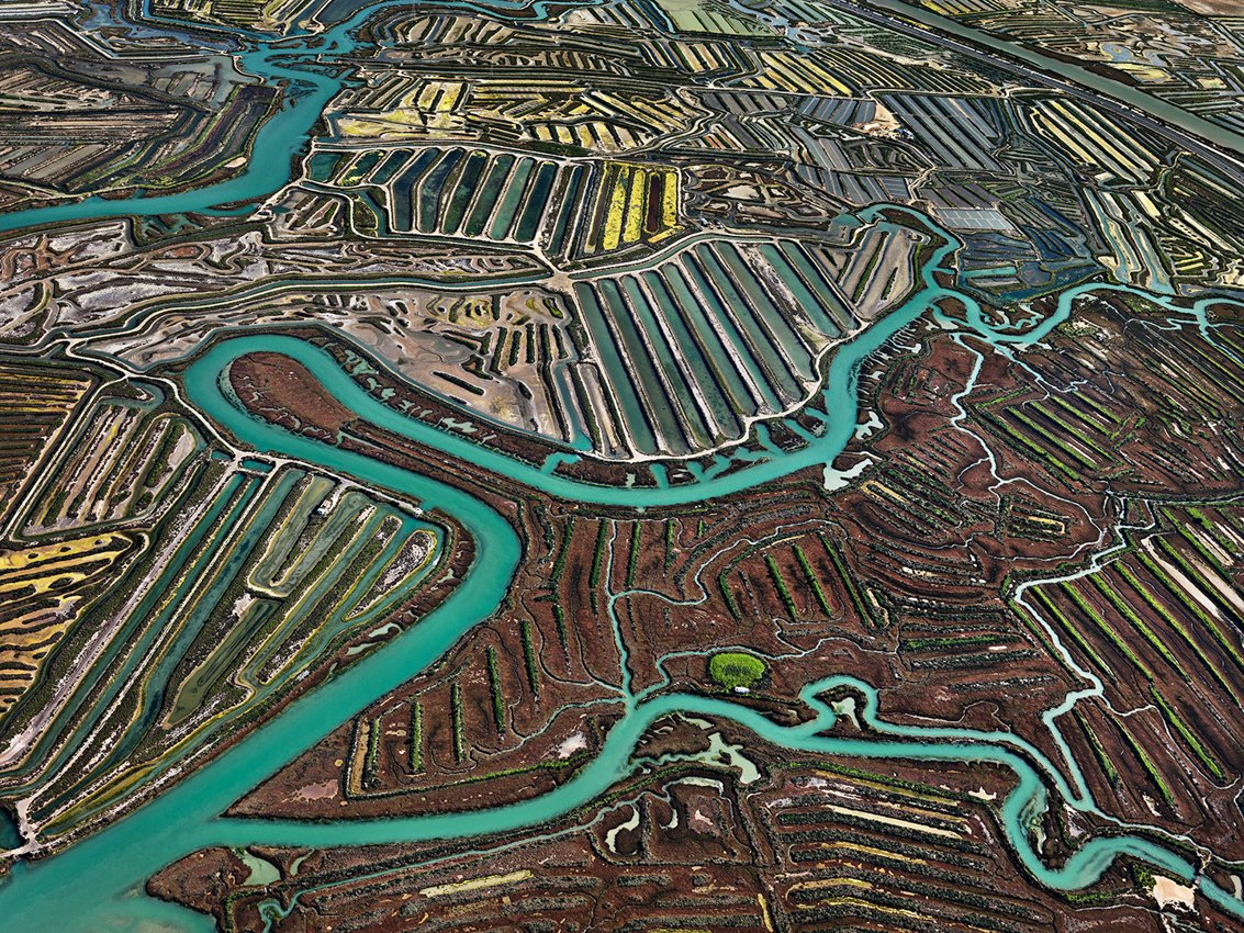 aerial photo of long winding rivers in a landscaped carved into farmland