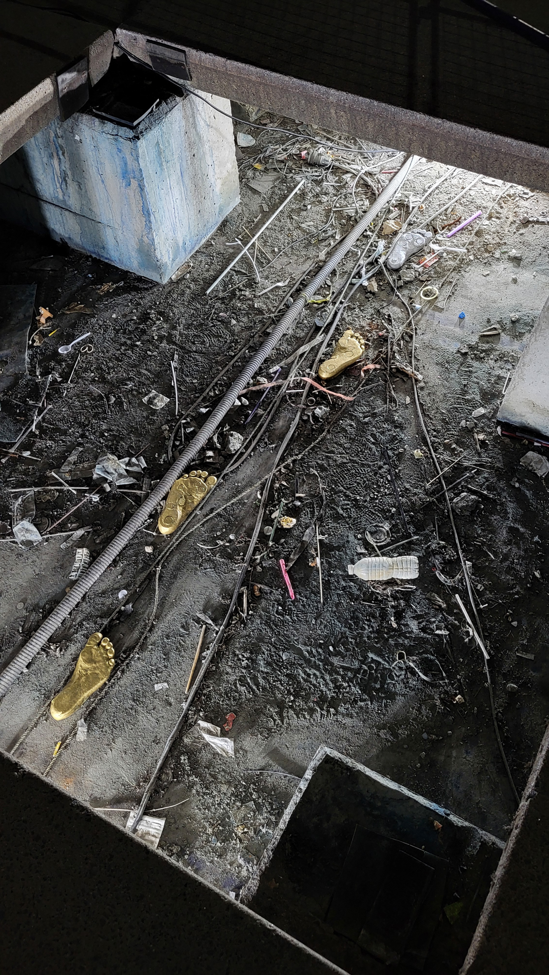 Nathan Philips Square deconstructed as part of the artwork Wellsping by Jenine Marsh. A close-up shot of the detritus and gold f