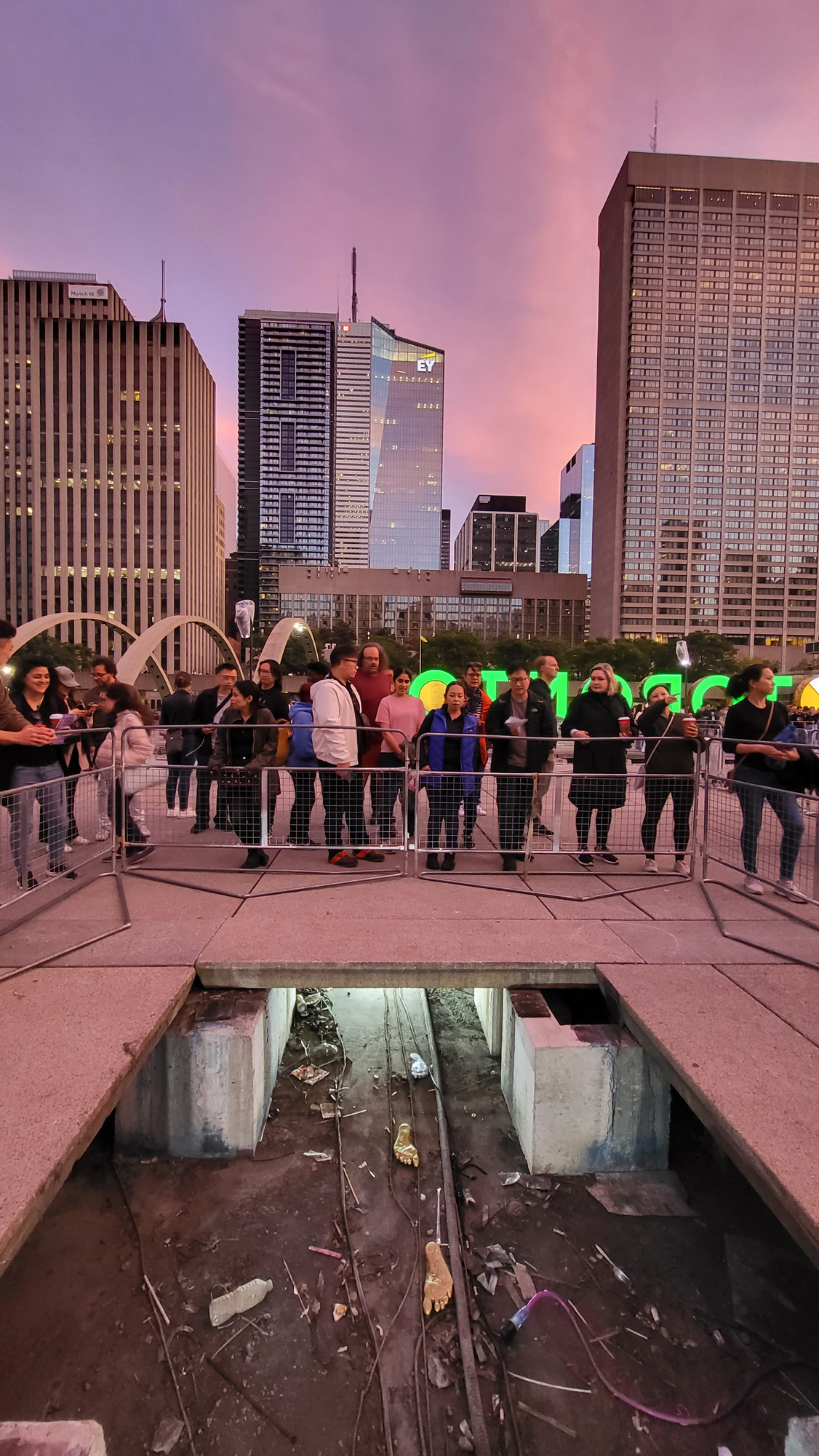 Nathan Philips Square deconstructed as part of the artwork Wellsping by Jenine Marsh. A crowd gathers at sunset to gaze upon th