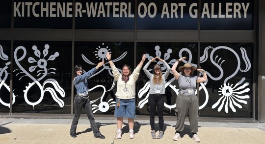 Photo of the four Camp Counsellors posed to spell out the letters of KWAG