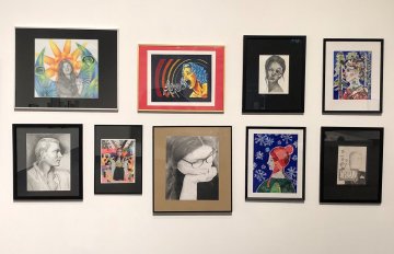 9 portraits hun on white gallery wall