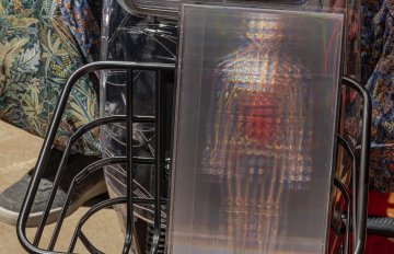 Close-up of the hologrpahic figure in the basket of The Medicine Seller sculptureal e-bike by Jason Lujan