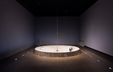A pair of pigeons perch on the remnants of a concrete fountain base leaving footprints in a circle